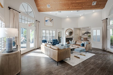 A modern living room with a large sofa and a wooden floor.